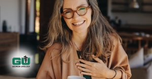 Woman smiling while putting left hand to chest