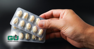 Man holding two packs of erectile dysfunction pills