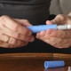 Man holding GLP-1 medication over table
