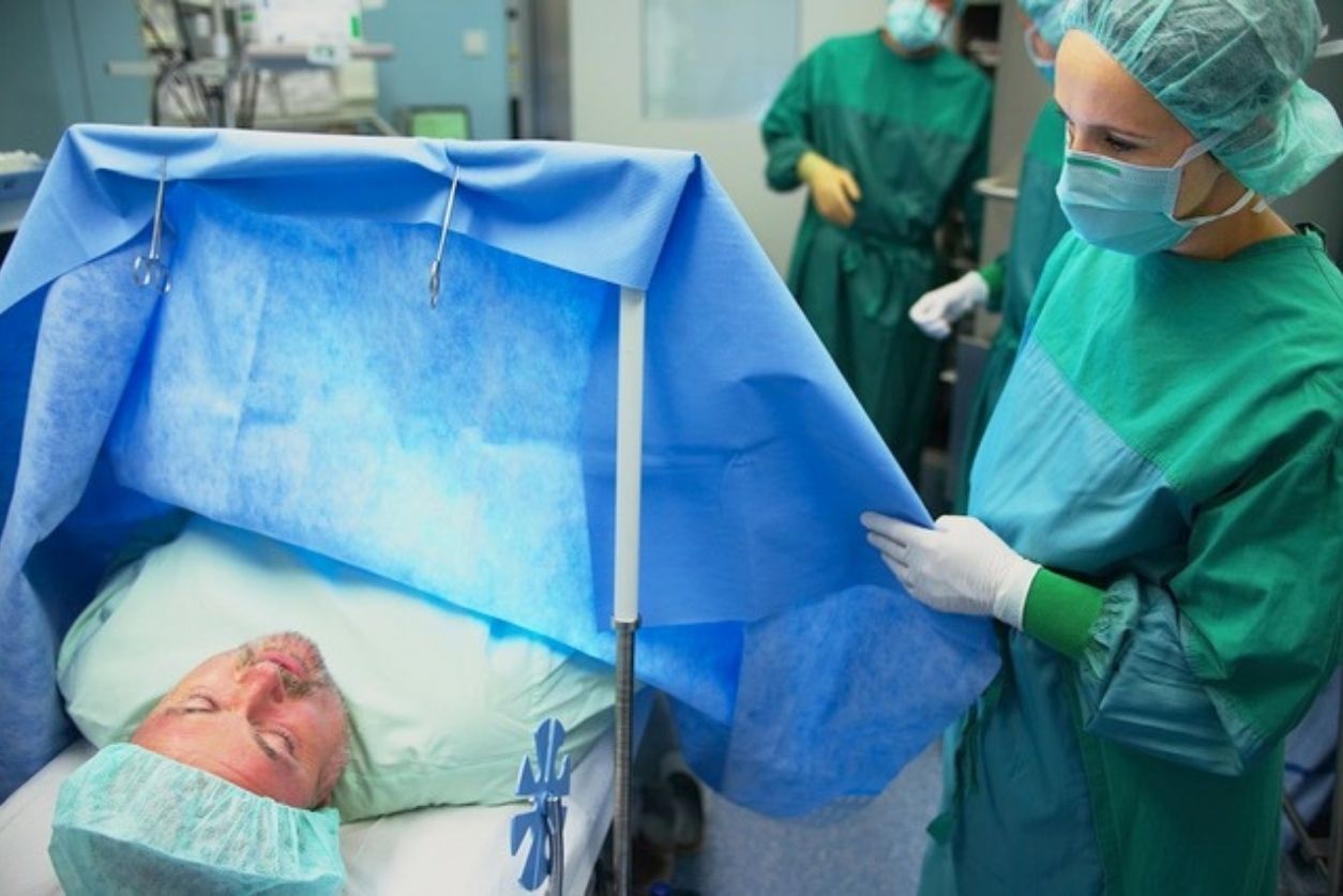 Doctor checking on patient under surgery.