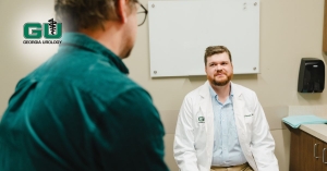 Dr. Kemper having conversation with patient in examination room, both sitting