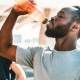 Man drinking water in bottle to stay hydrated