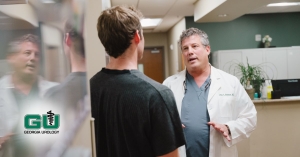 Dr. Kriteman having a discussion with patient in the lobby, patient back turned to camera