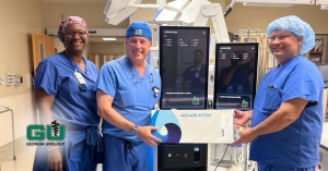 Dr. Lewis Kriteman alongside other providers holding Aquablation package standing in front of Hydros system