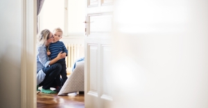 Mother kissing cheek of toddler son
