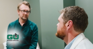 Dr. Kemper having discussion with patient in examination room
