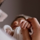Father holding baby with Spina Bifida, focus on baby holding fathers finger