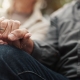 Older man and partner holding hands