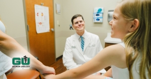 Pediatric patient holding mothers hand while at an appointment with Dr. Smith