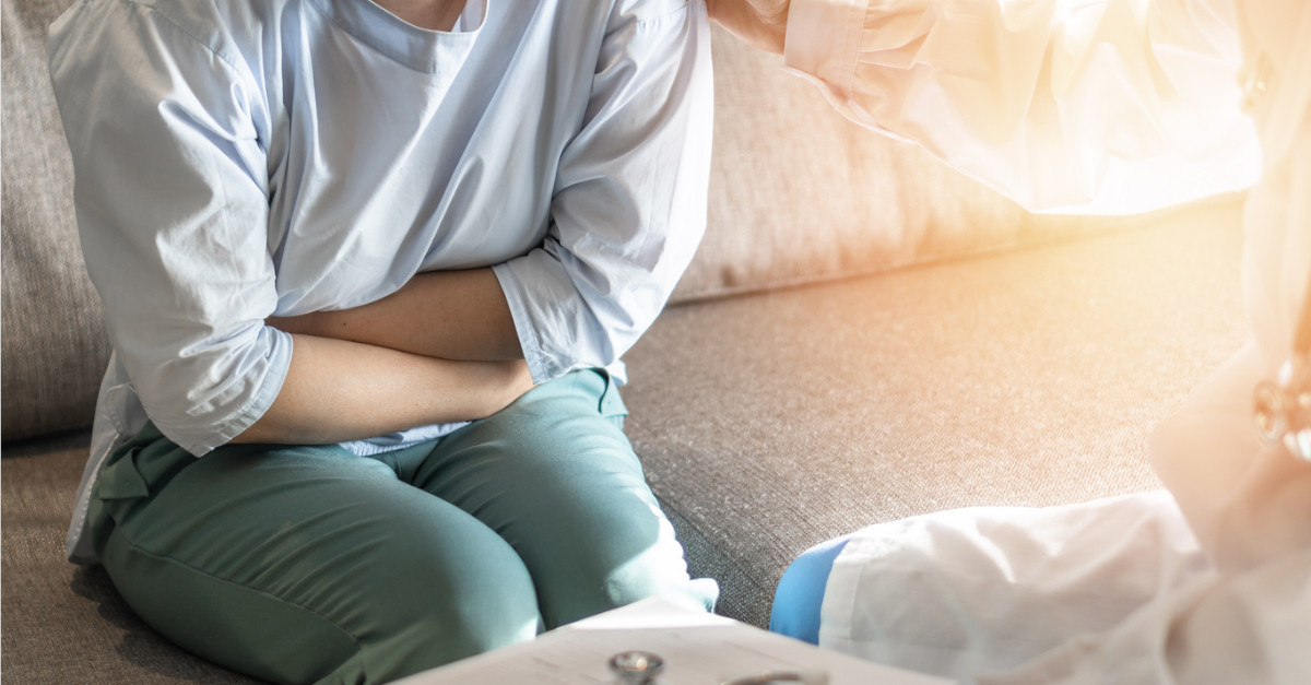 Woman holding stomach in pain