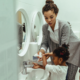 Female teacher and two little girls washing their hands at the bathroom sink, Breaking the Barriers on Bathroom Passes