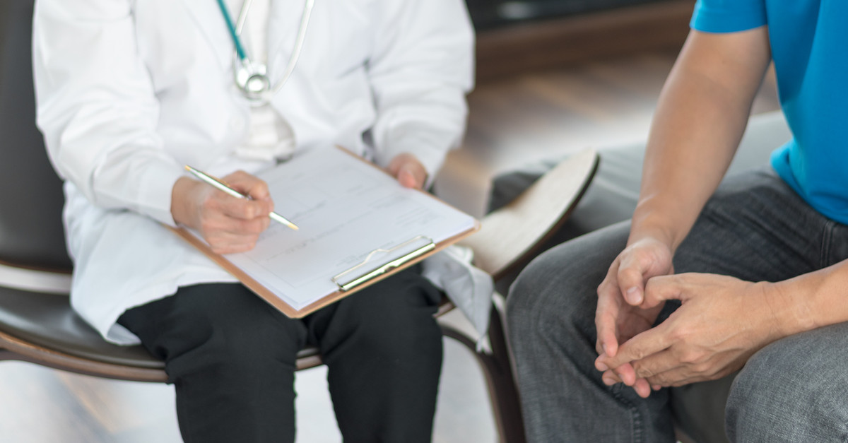 doctor speaking to male patient