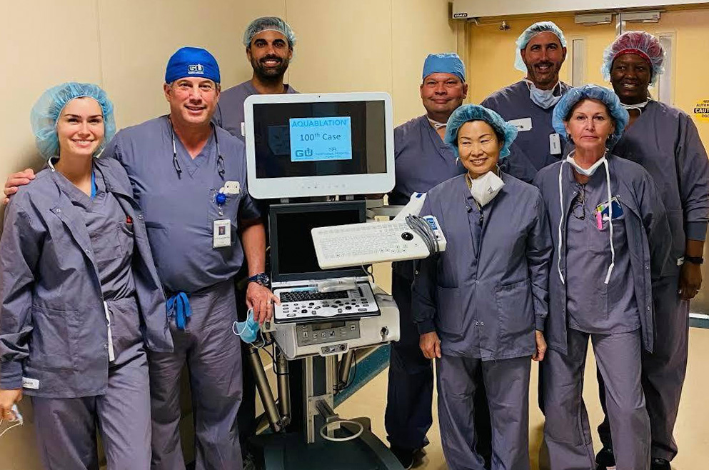 Georgia Urology physicians stand beside aquablation machine.