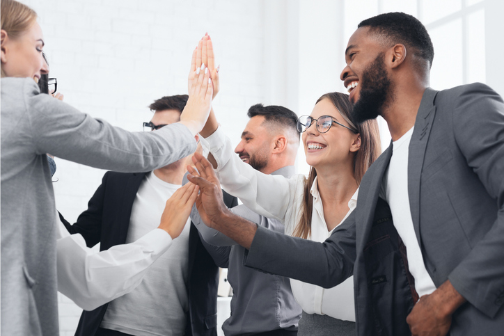 Team achievement, diverse business people giving high five at meeting