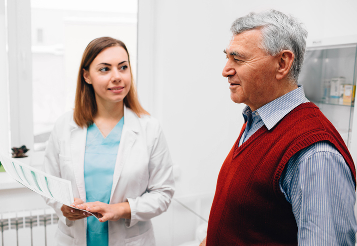 elderly man consults with his doctor in clinic, discussing Urethral Stricture.