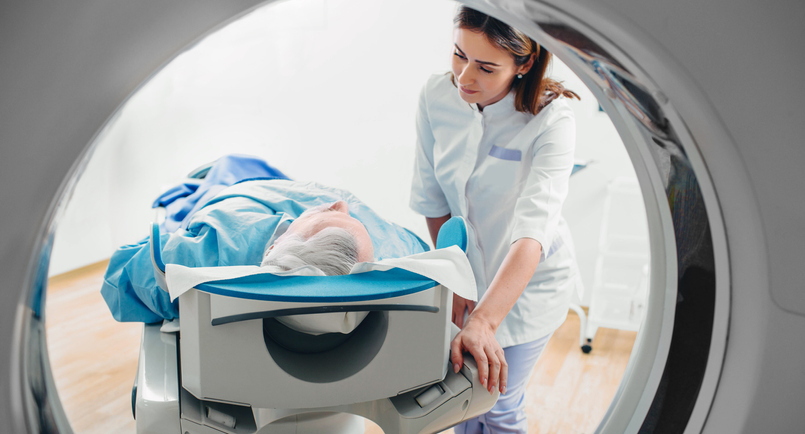 friendly doctor talking to patient . CT Scan in hospital