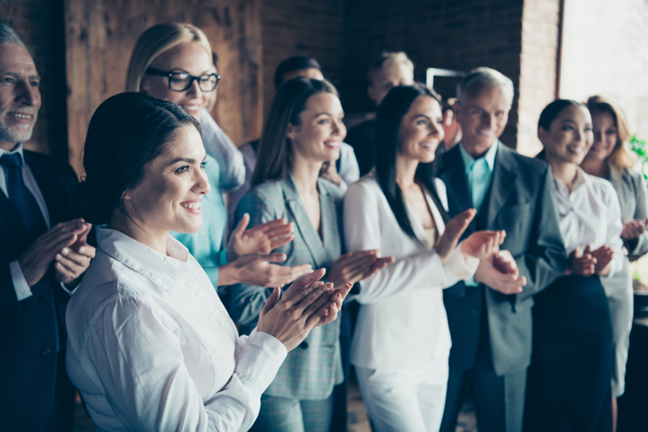 Close up side profile blurry view photo different age members business people stand she her he him his together best brigade show appreciation clap hands arms project power formal wear jackets shirts.