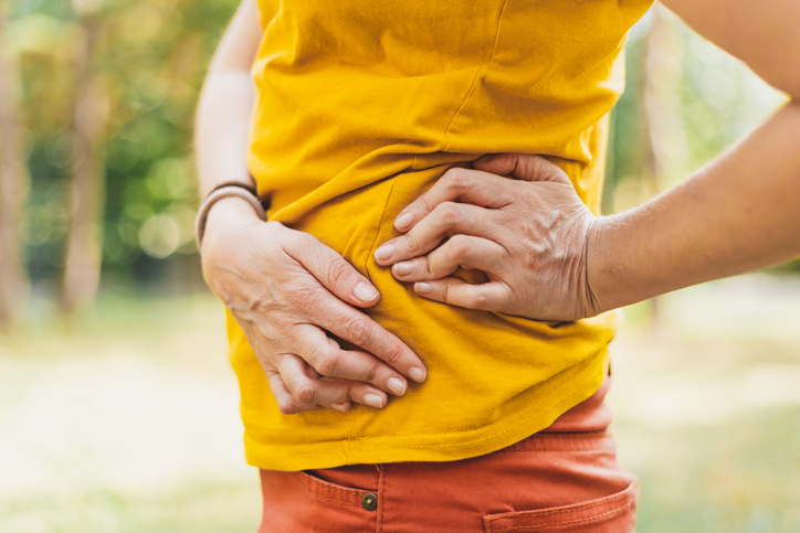 Woman having osteoporosis and painful arthritis to her hands - Young person having bone ache in the hip area, possibly from pelvic floor prolapse.