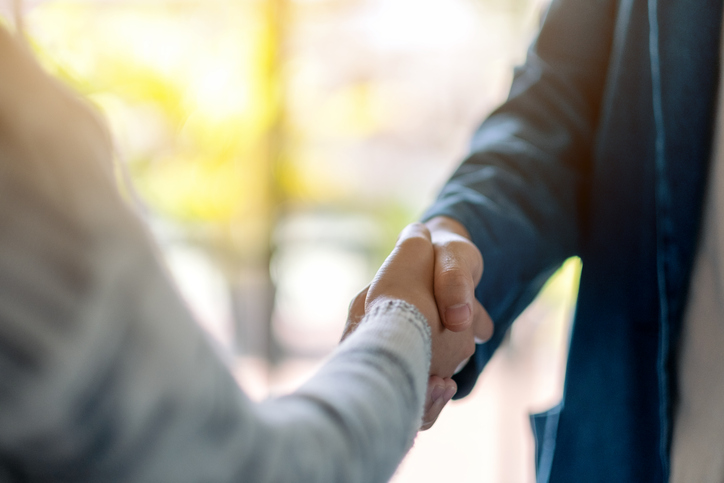 Closeup image of two people shaking hands.