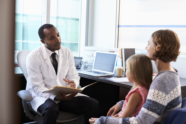 Pediatrician Meeting With Mother And Child In Hospital, discussing biofeedback.