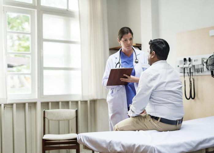 A urologist discussing Cystoscopy with her patient