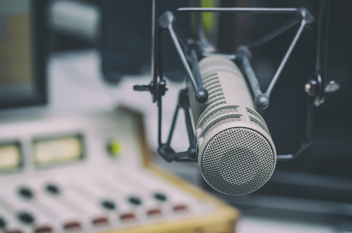 Professional microphone and audio mixer in radio studio.