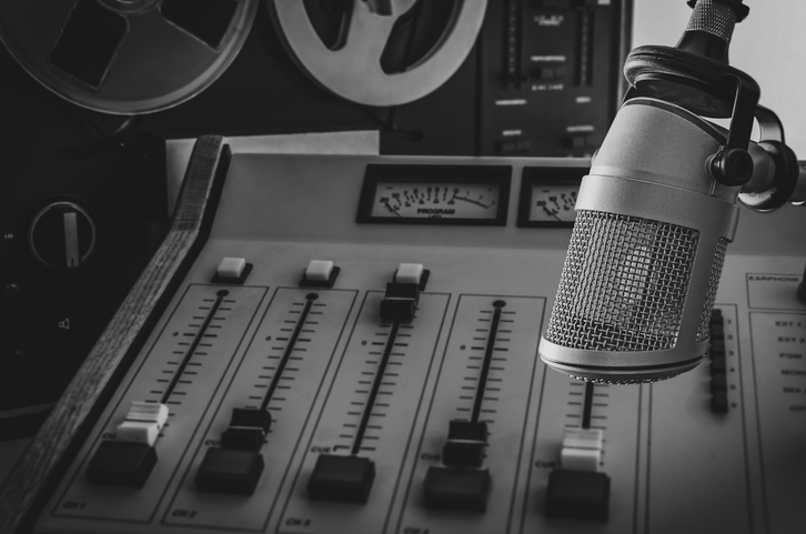 Professional microphone and audio mixer in radio studio.