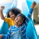 Two happy kids on slide