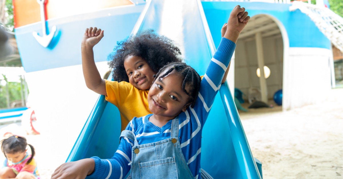 Two happy kids on slide