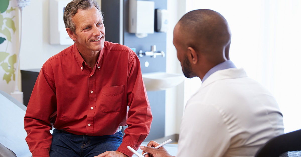 Urologist discussing cryo-surgical ablation with positive senior patient.