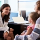 Pediatrician Meeting With Mother And Child In Hospital, teaching them about Protecting Your Child's Kidneys.