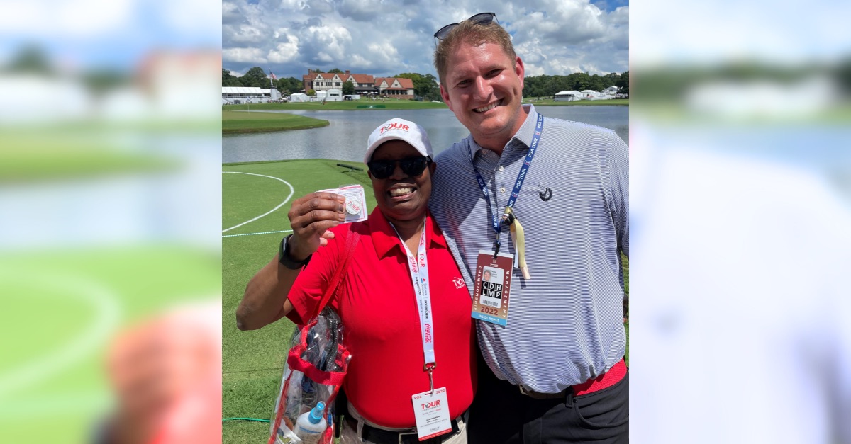 Smiling woman and man at golf game